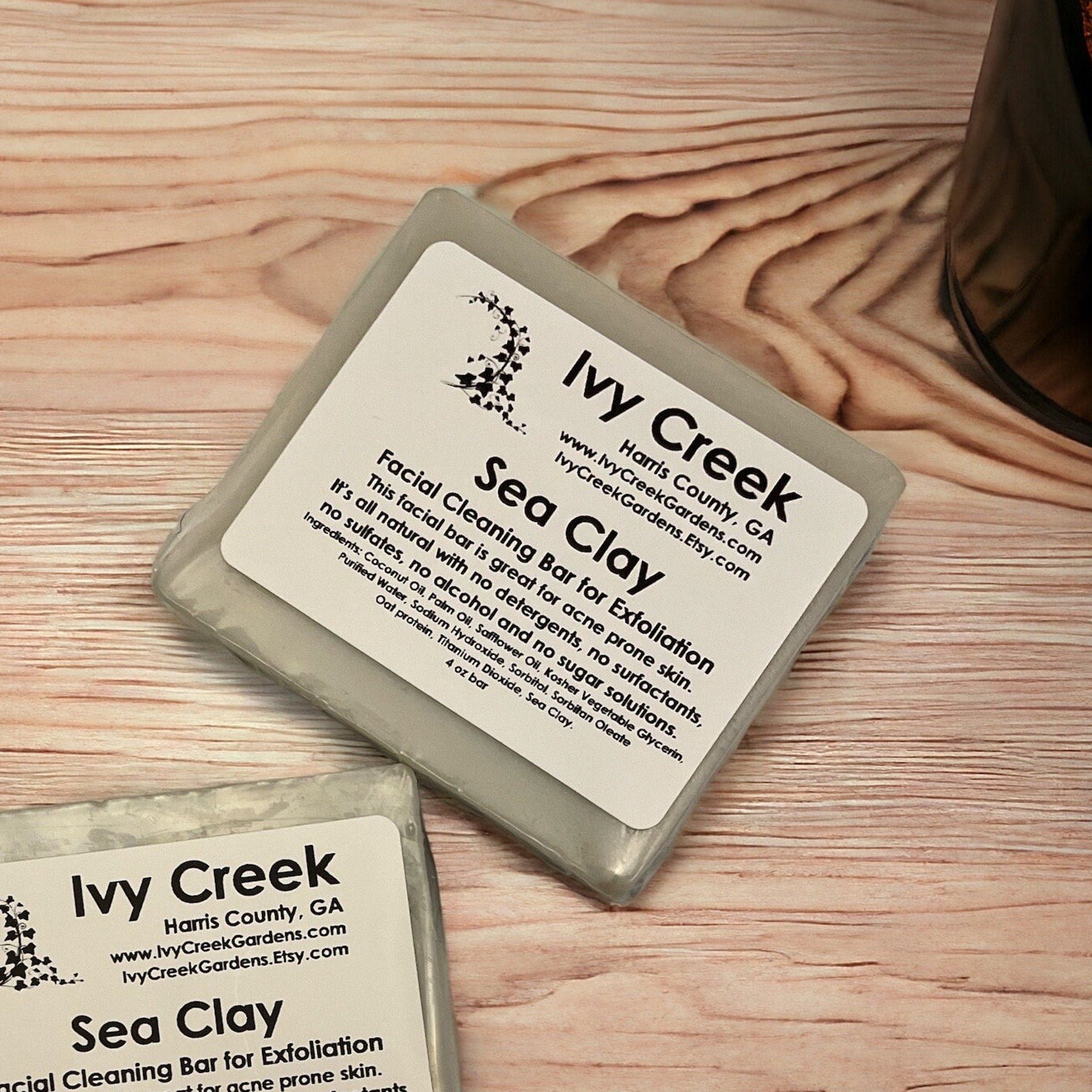 Facial Cleanser bar, gray rectangular bar, "Ivy Creek" label, on wood surface