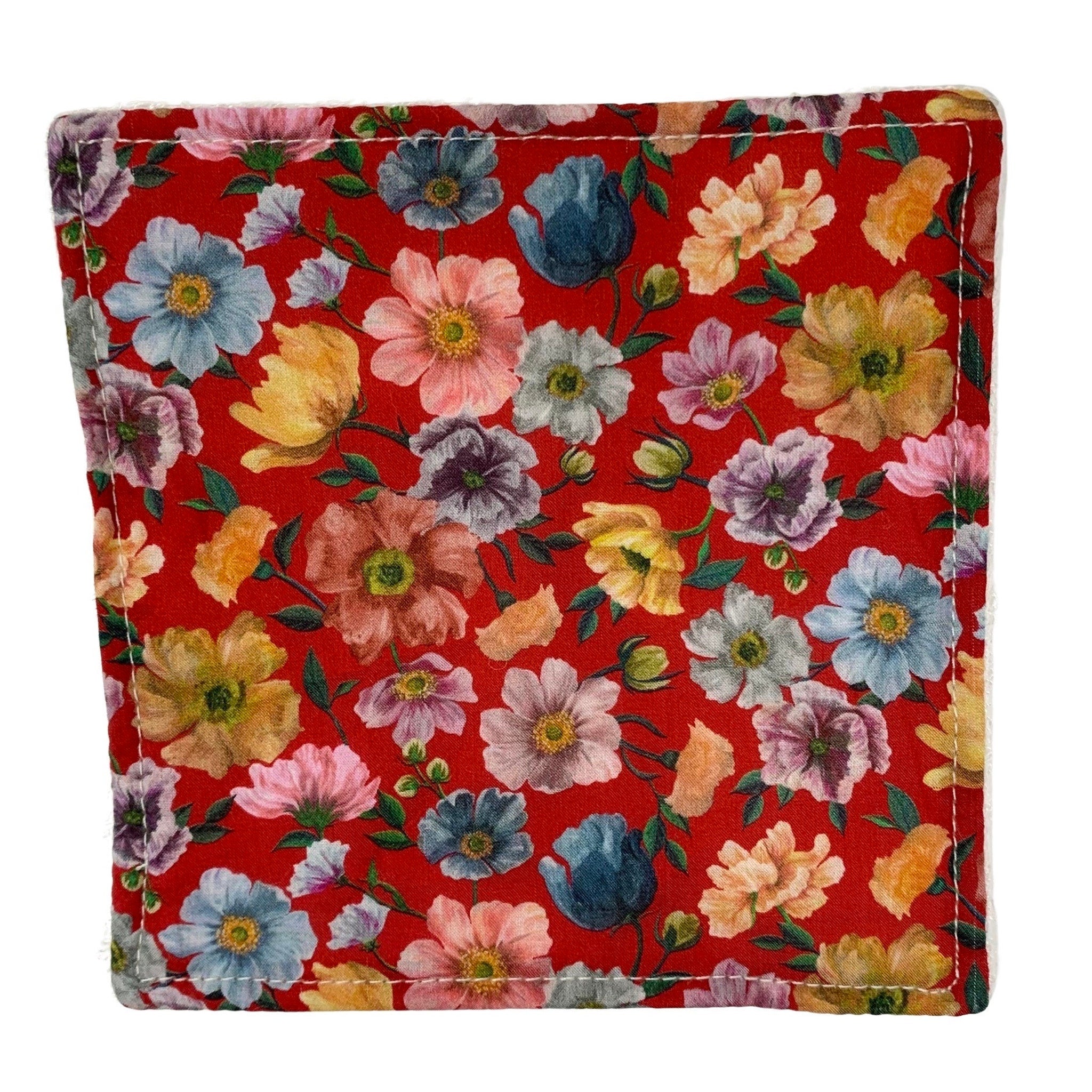 Floral print coaster with red background, colorful flower pattern, and white stitched edge