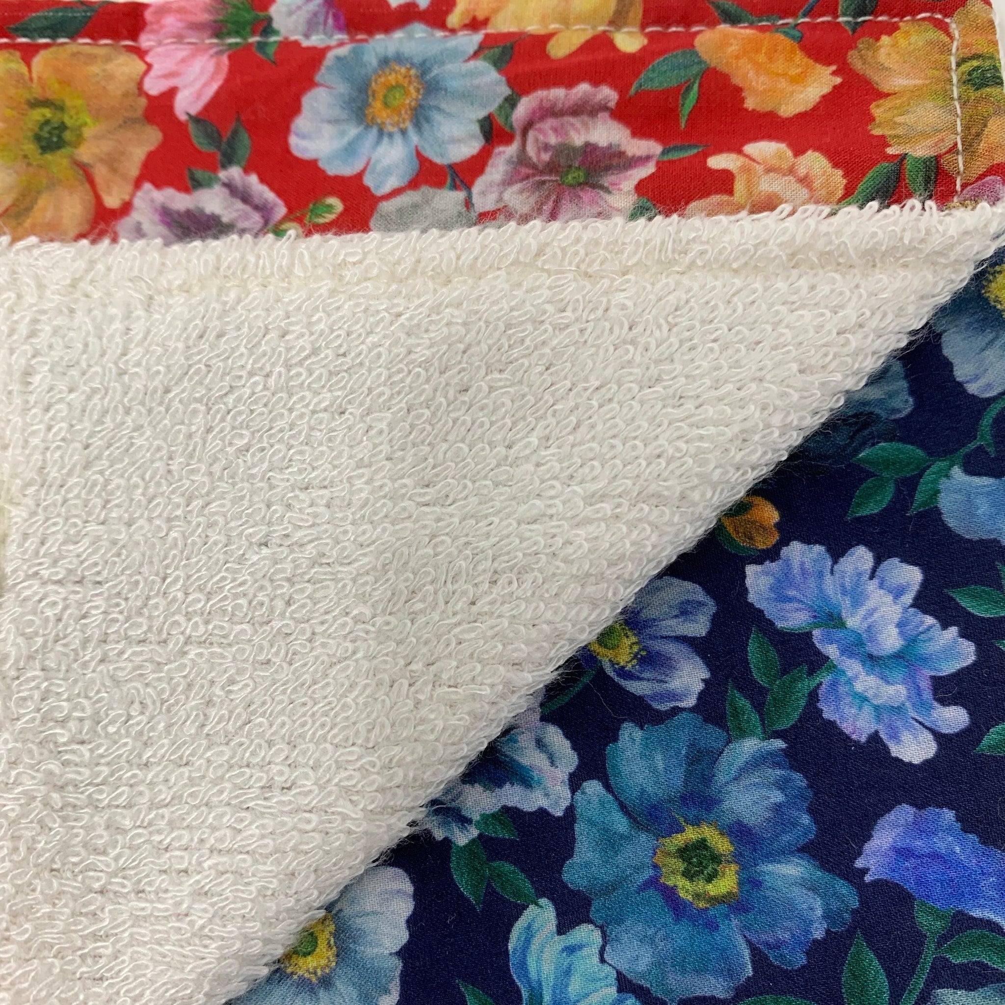 Floral fabric with red, blue, and white colors with white terry cloth material