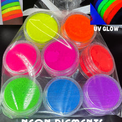 Eight vibrant neon matte eyeshadow pans in fluorescent pink, orange, yellow, green, blue, purple, white, and black
