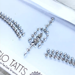 Body jewels with clear rhinestones and silver teardrop shapes on white background