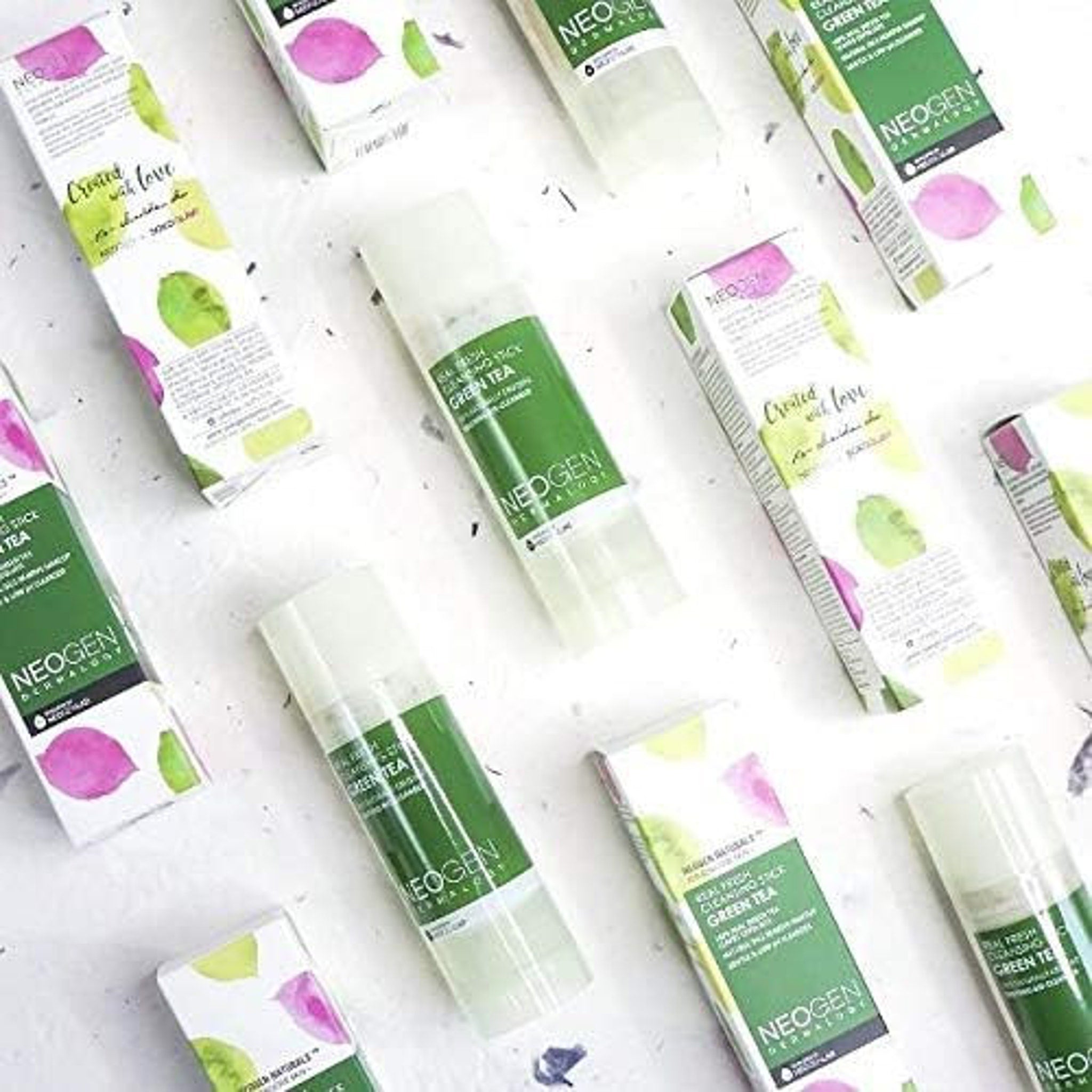 Green tea cleansing stick with white, green, and pink watercolor design, NEOGEN brand visible on packaging
