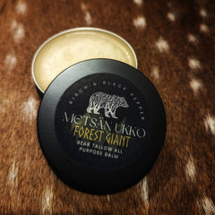 Bear tallow salve with black tin, light yellow balm, and Metsan Ukko branding on lid