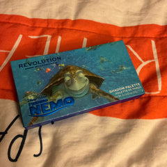 Disney Finding Nemo Crush eyeshadow palette featuring ocean-blue shades with turtle shell imprint on glossy compact