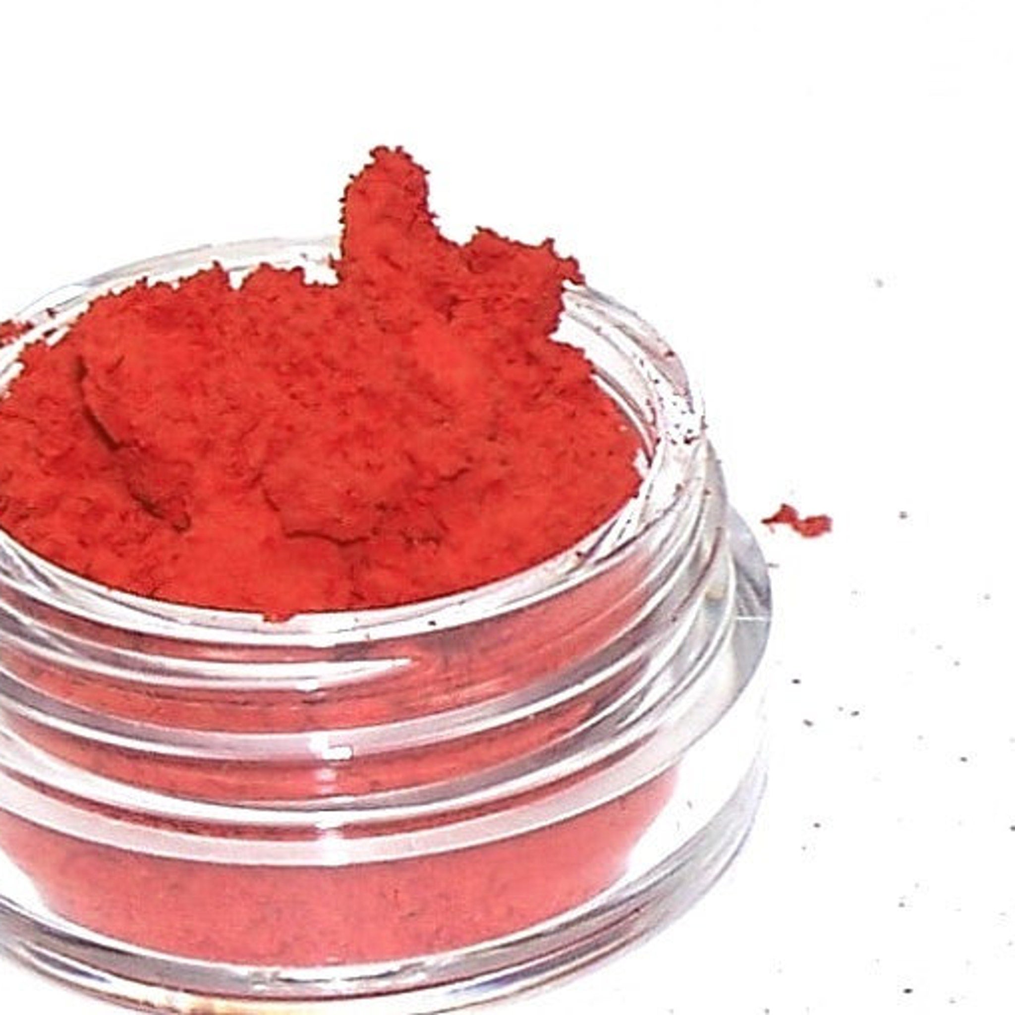 Close-up of matte red eye shadow pan showing rich pigment and smooth texture
