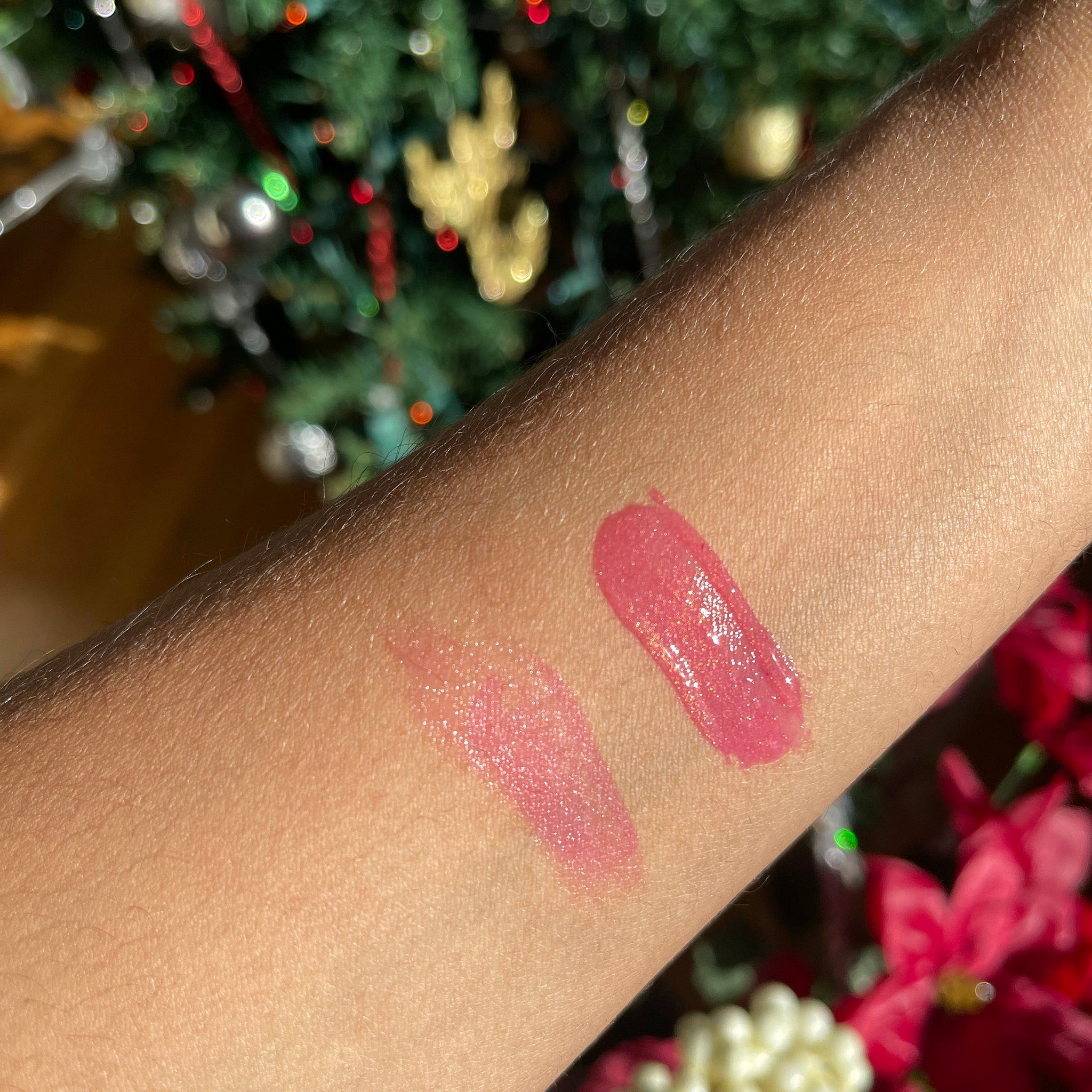 Lip gloss swatches, pink glossy texture, applied on arm, holiday background