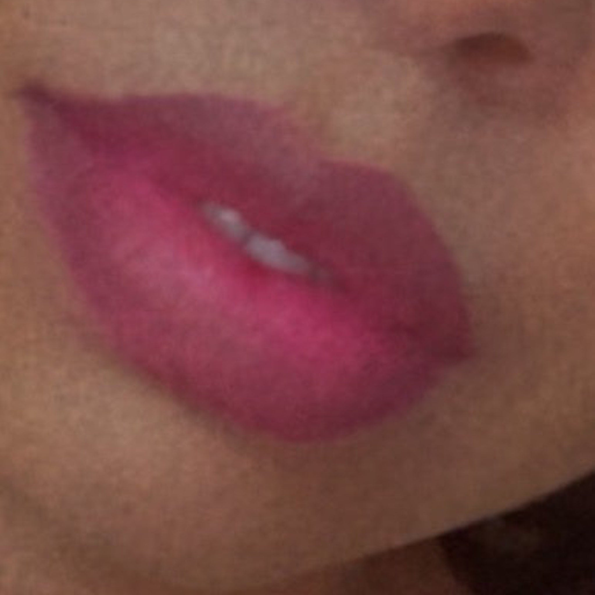 Pink lipstick on lips, showing color and shape of the mouth