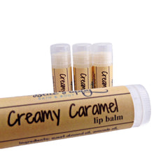 Lip balm tubes with beige labels, white caps, and "Creamy Caramel" text visible
