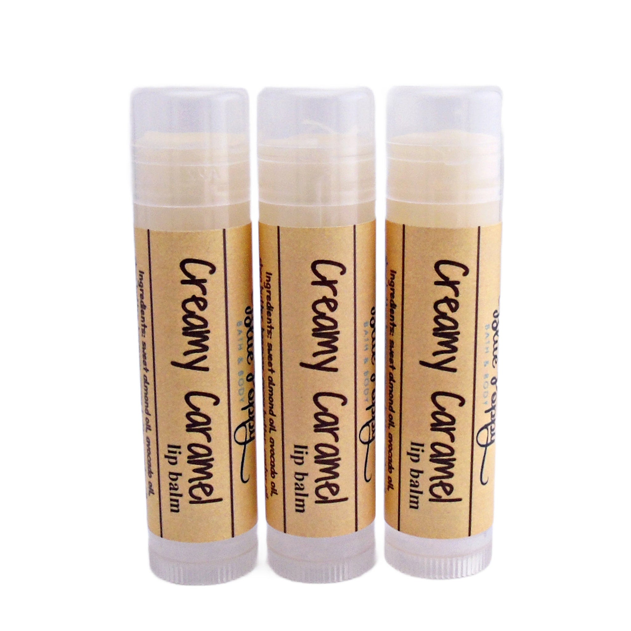 Lip balm tubes with beige labels, clear caps, and "Creamy Caramel" text by BluePoppyBath