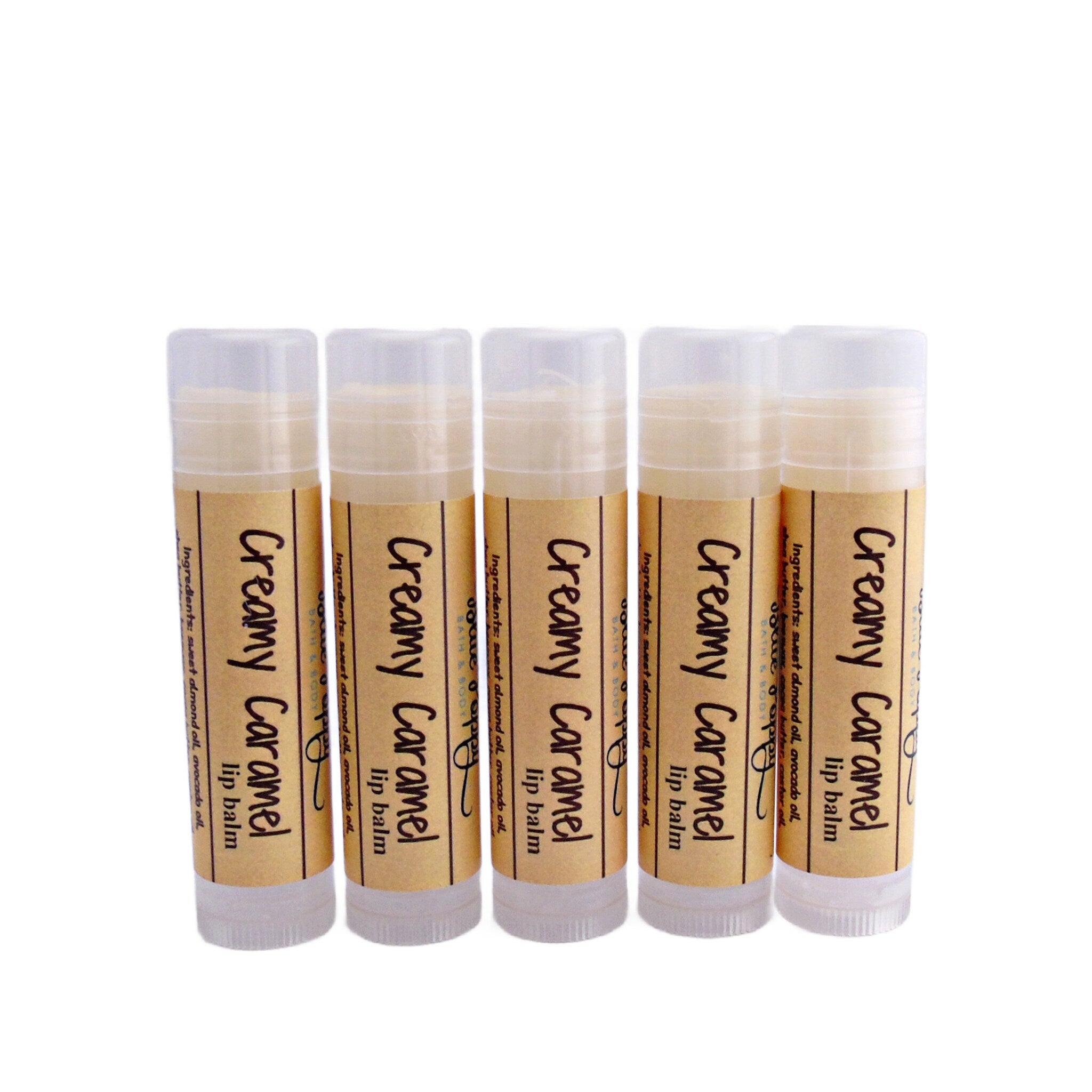 Lip balm tubes with brown label, beige balm, and clear plastic casing, labeled "Creamy Caramel