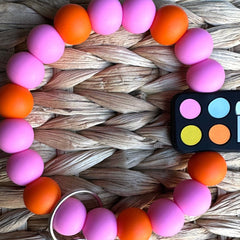 Mini eyeshadow palette keychain with vibrant multicolor makeup shades in a compact rectangular case