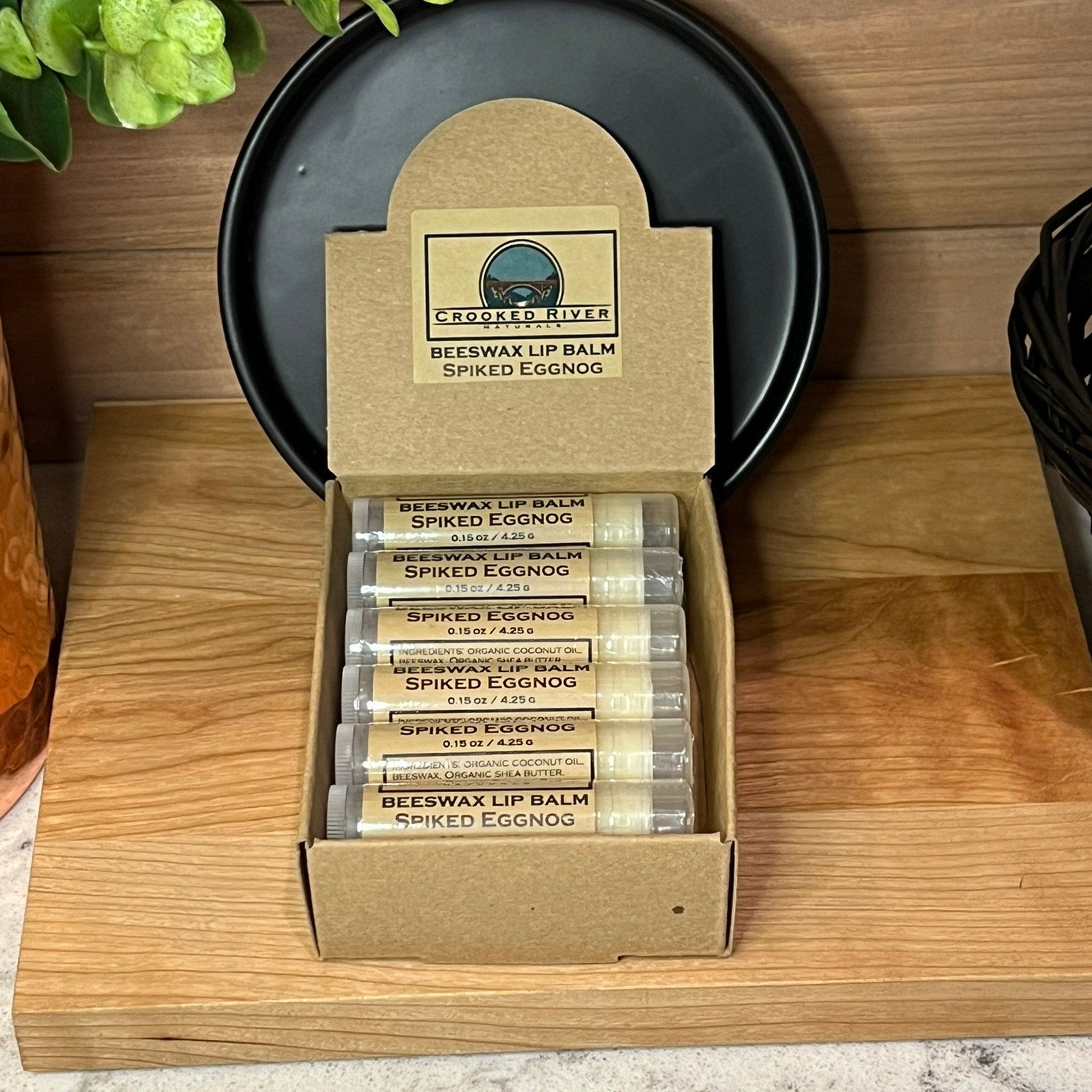 Beeswax lip balm tubes in clear, brown, and white packaging, Crooked River Naturals brand