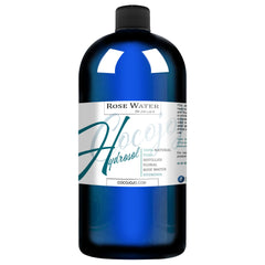 Rose water bottle, blue glass, black cap, with label "CocoJojo Hydrosol