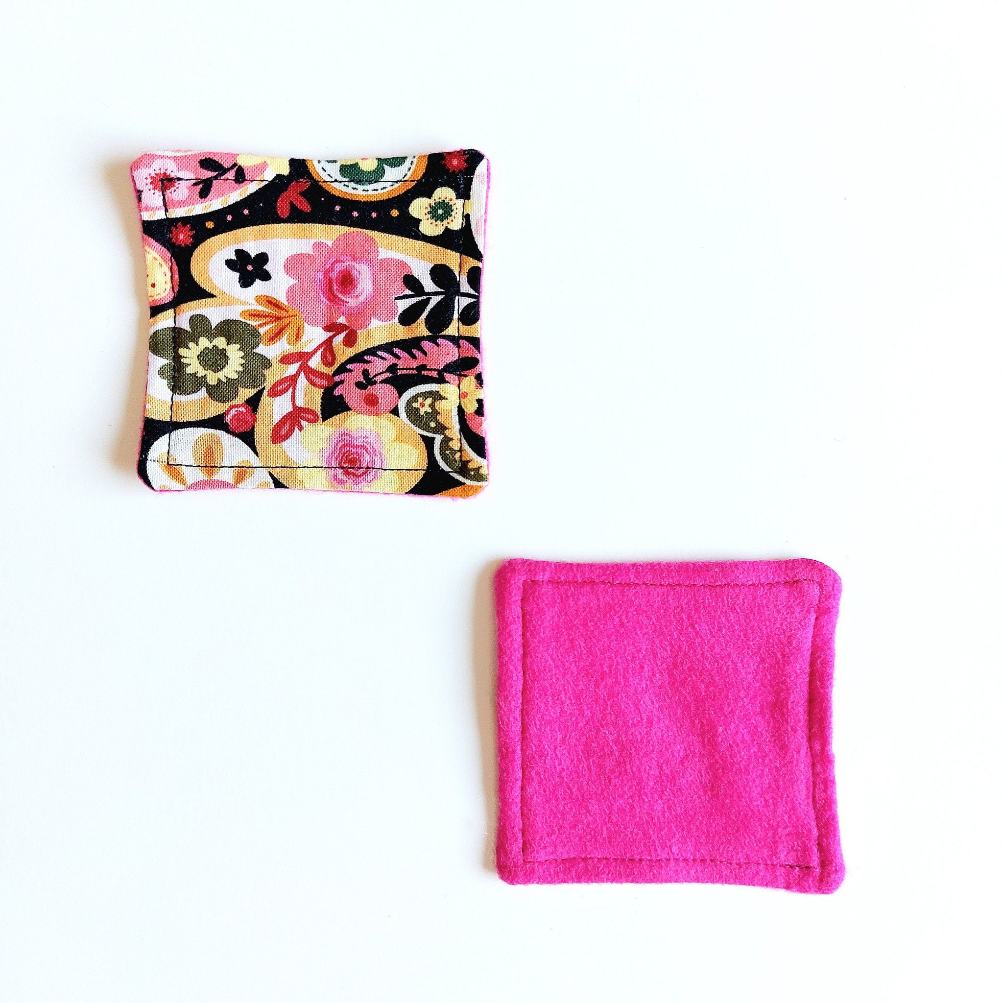 Fabric coasters with floral pattern, pink felt, and stitched edges