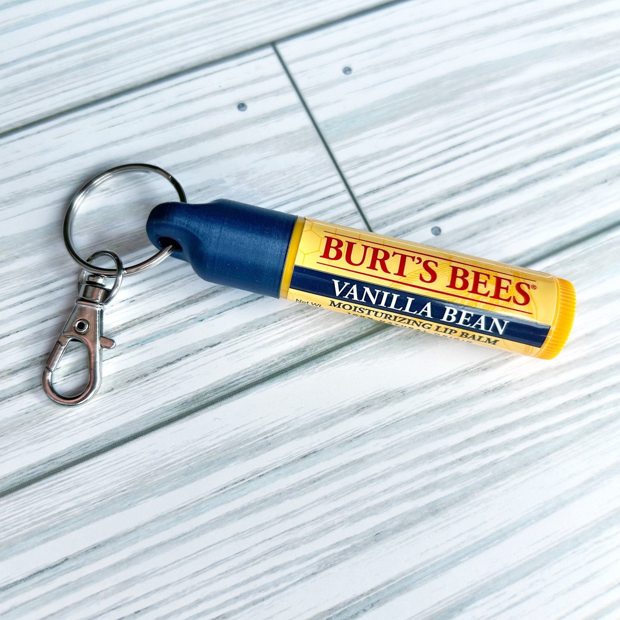 Burt's Bees lip balm with blue cap and silver keychain, Vanilla Bean flavor