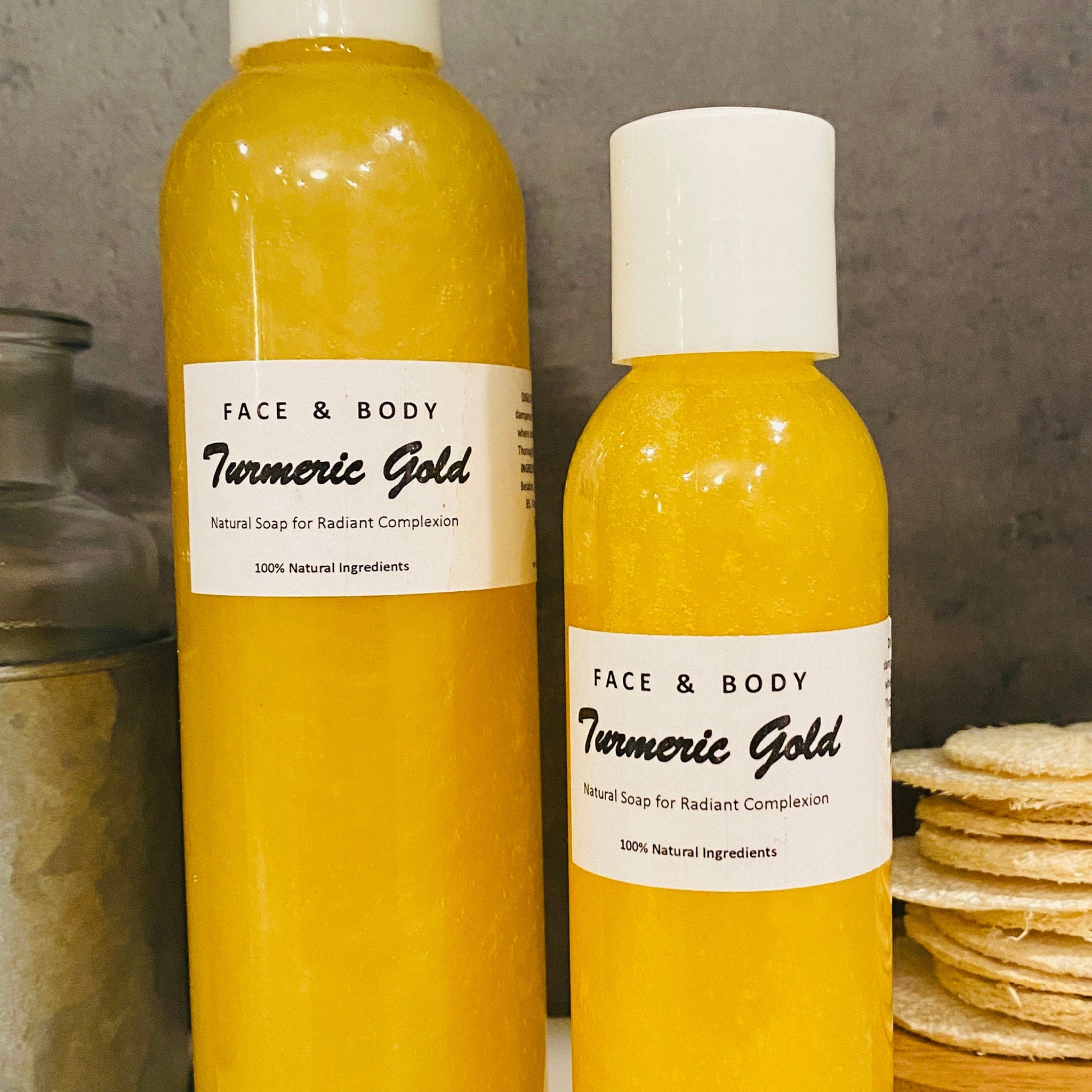 Golden turmeric liquid soap in a sleek amber bottle with loofah, showcasing natural vegan skincare for radiant glow