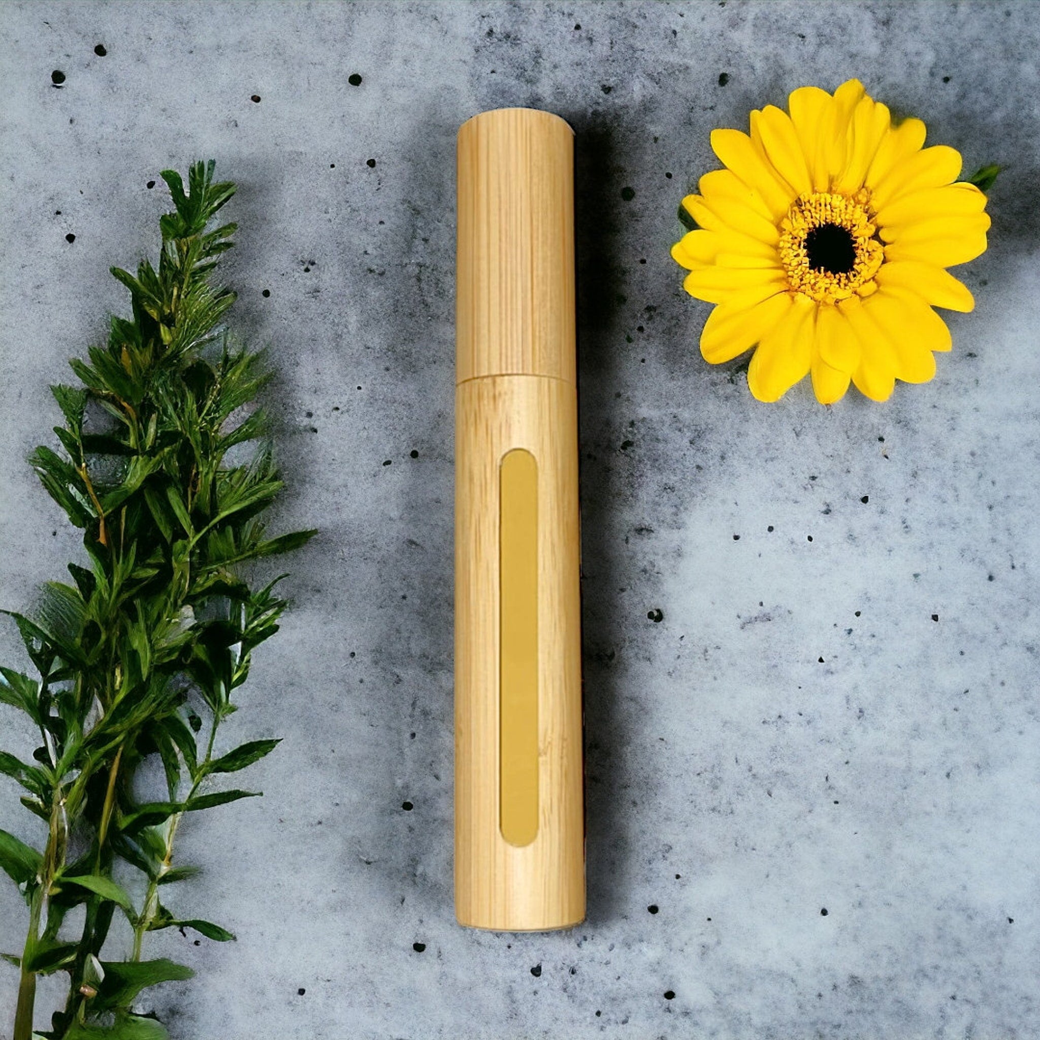 Mascara tube, light brown bamboo, gold accent, with yellow flower and green leaves