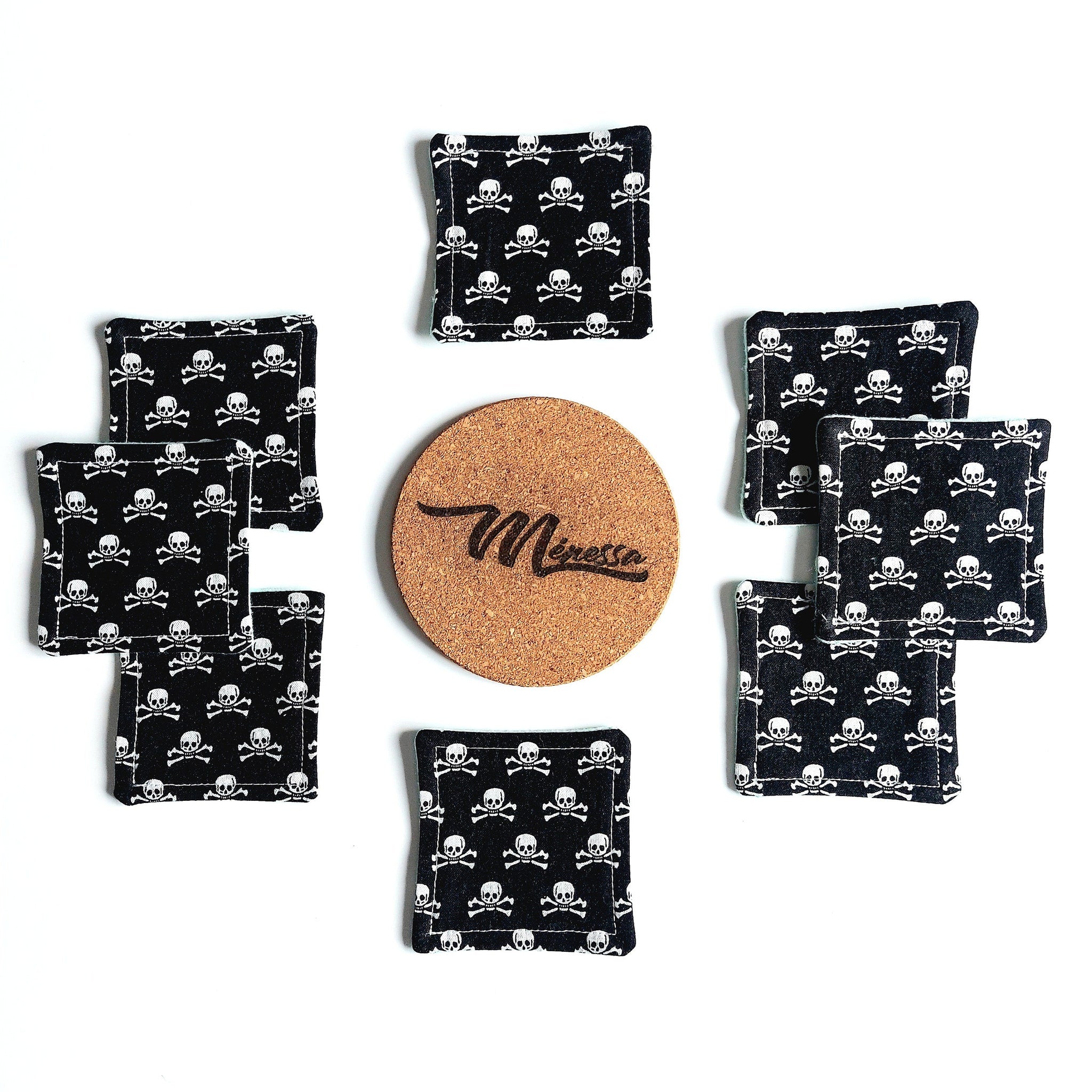 Coasters with black skull pattern, square shape, and cork center with Meressa logo