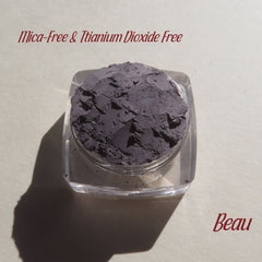 Eye shadow, matte gray powder in clear jar, Beau brand name visible