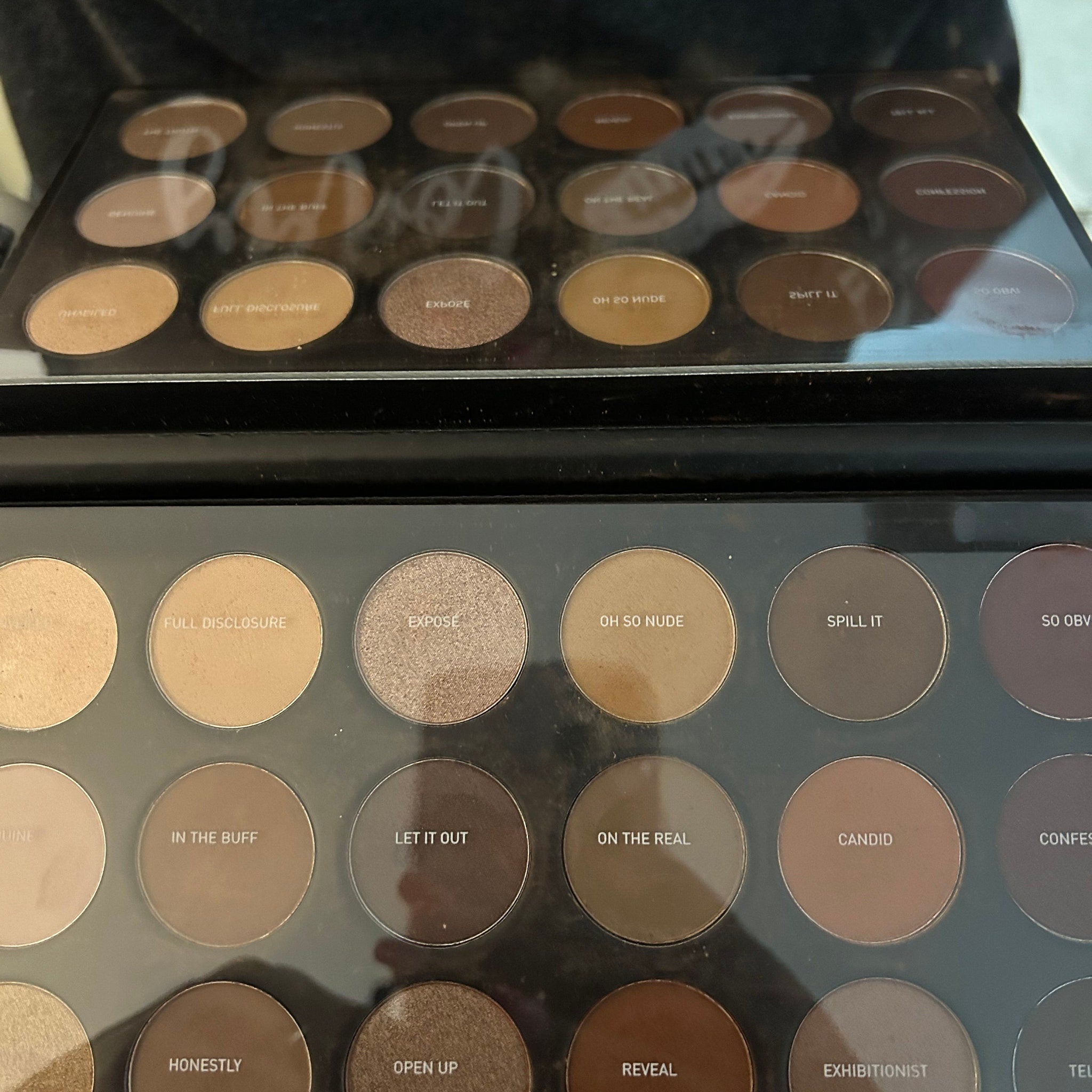 Close-up of Morphe Eye Shadow Palette showing vibrant matte and shimmer shades in a sleek black case