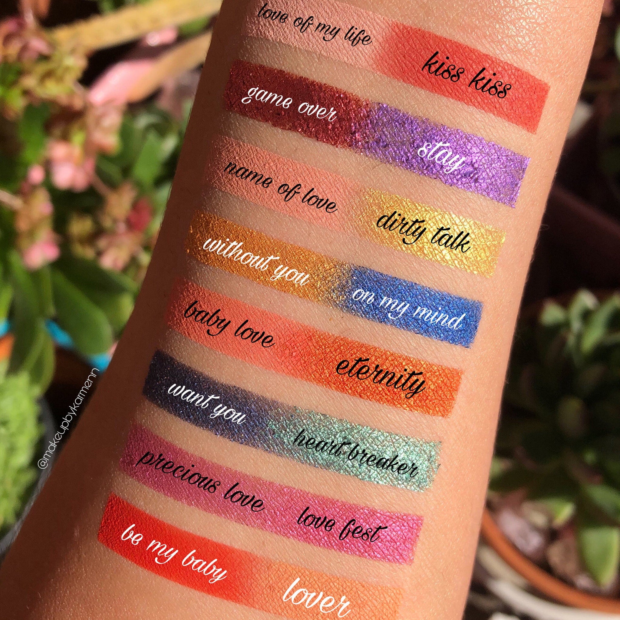 Lipstick swatches in various colors, metallic and matte finishes, applied on skin, with text labels