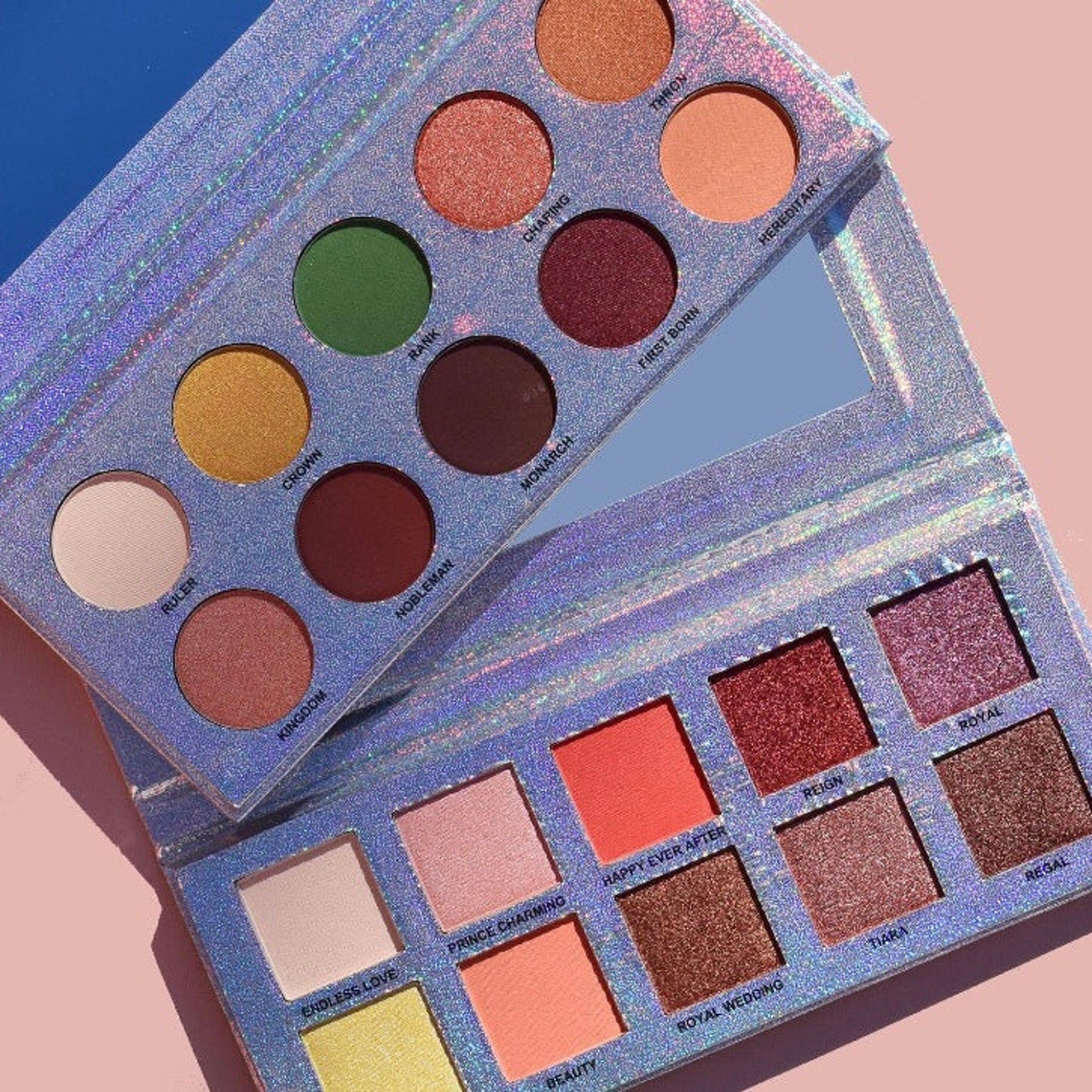 Eyeshadow palette with multiple colors, glittery silver packaging, and mirror included