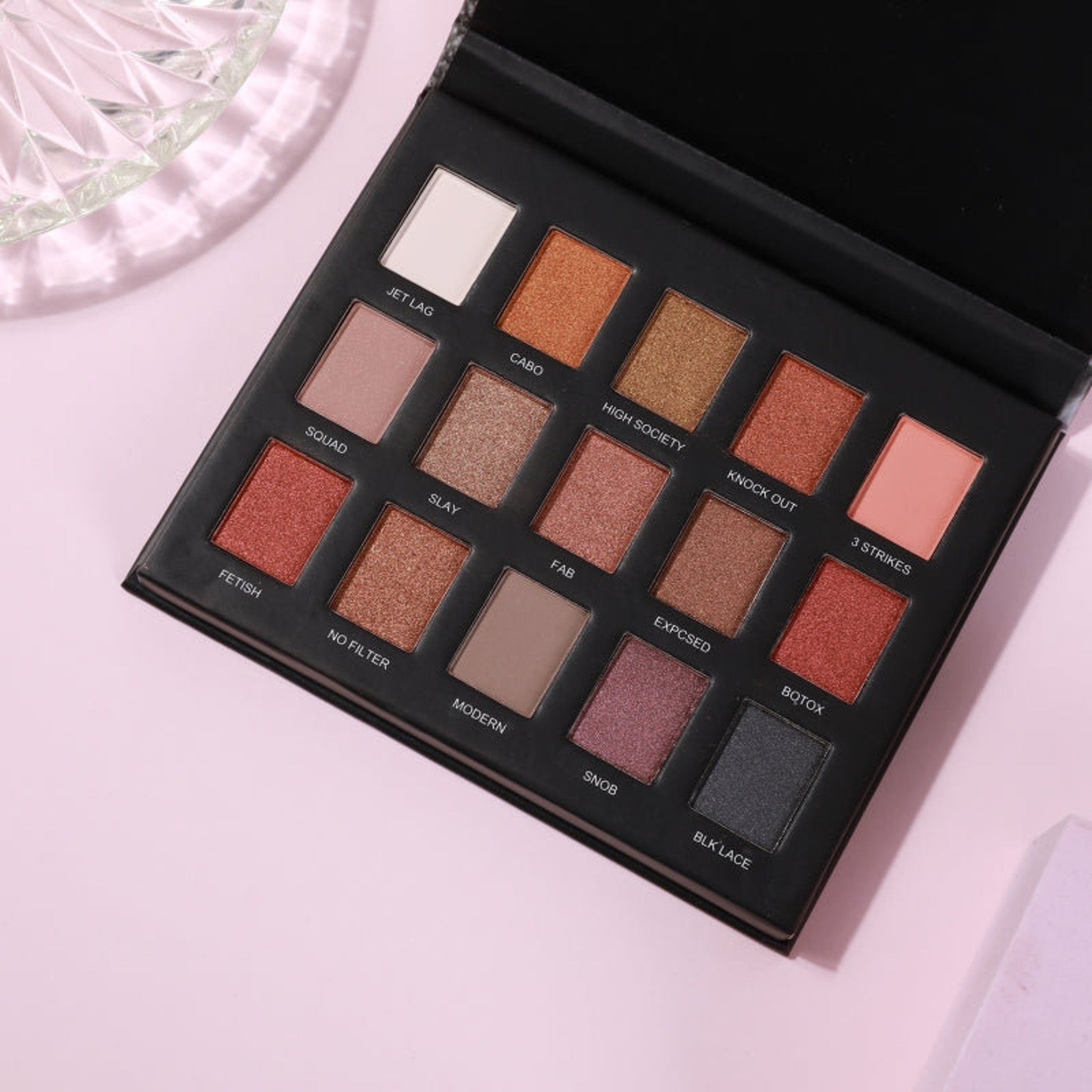 Matte eyeshadow palette with various colors in black case, Prolux brand visible