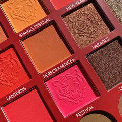 Eyeshadow palette with multiple colors, patterned shades, and red frame