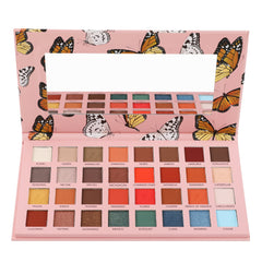 Eyeshadow palette with pink butterfly pattern, multiple color eyeshadows, and a mirror inside