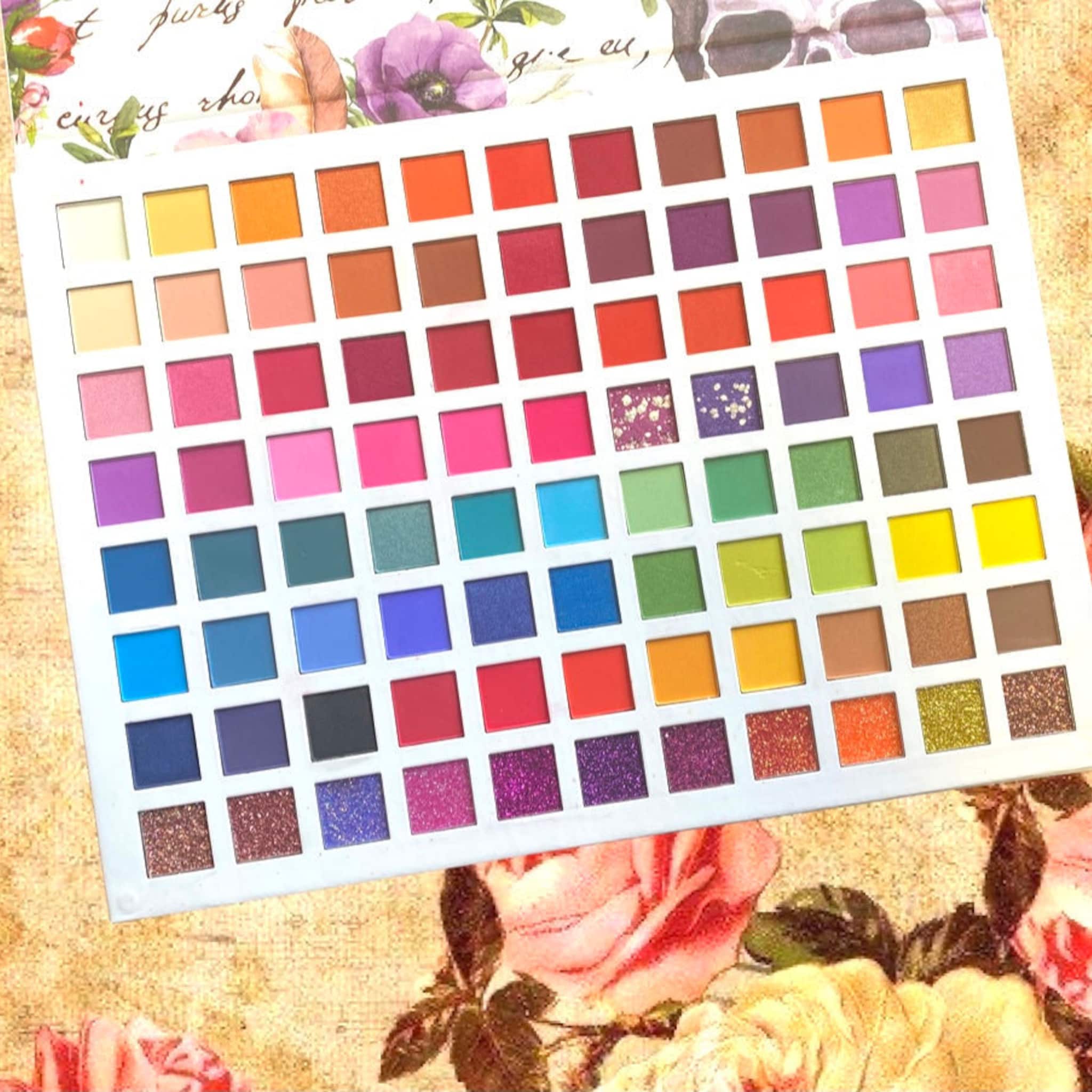 Eyeshadow palette with multiple colors including pink, orange, and glitter shades in square pans