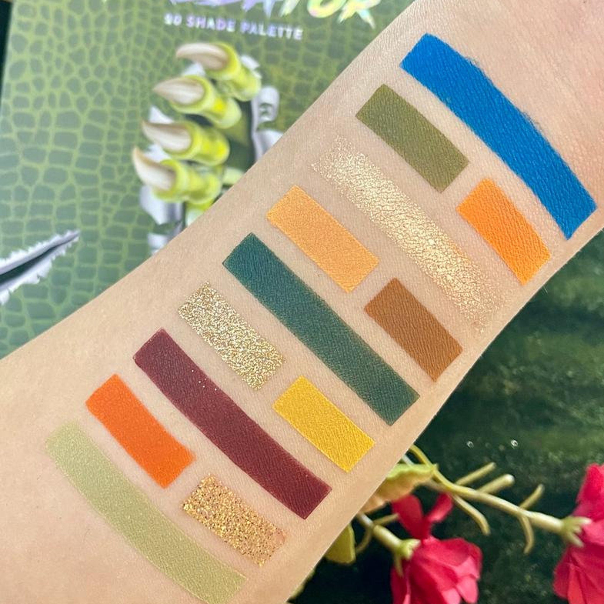 Eyeshadow swatches in multiple colors including blue, gold glitter, and orange on skin