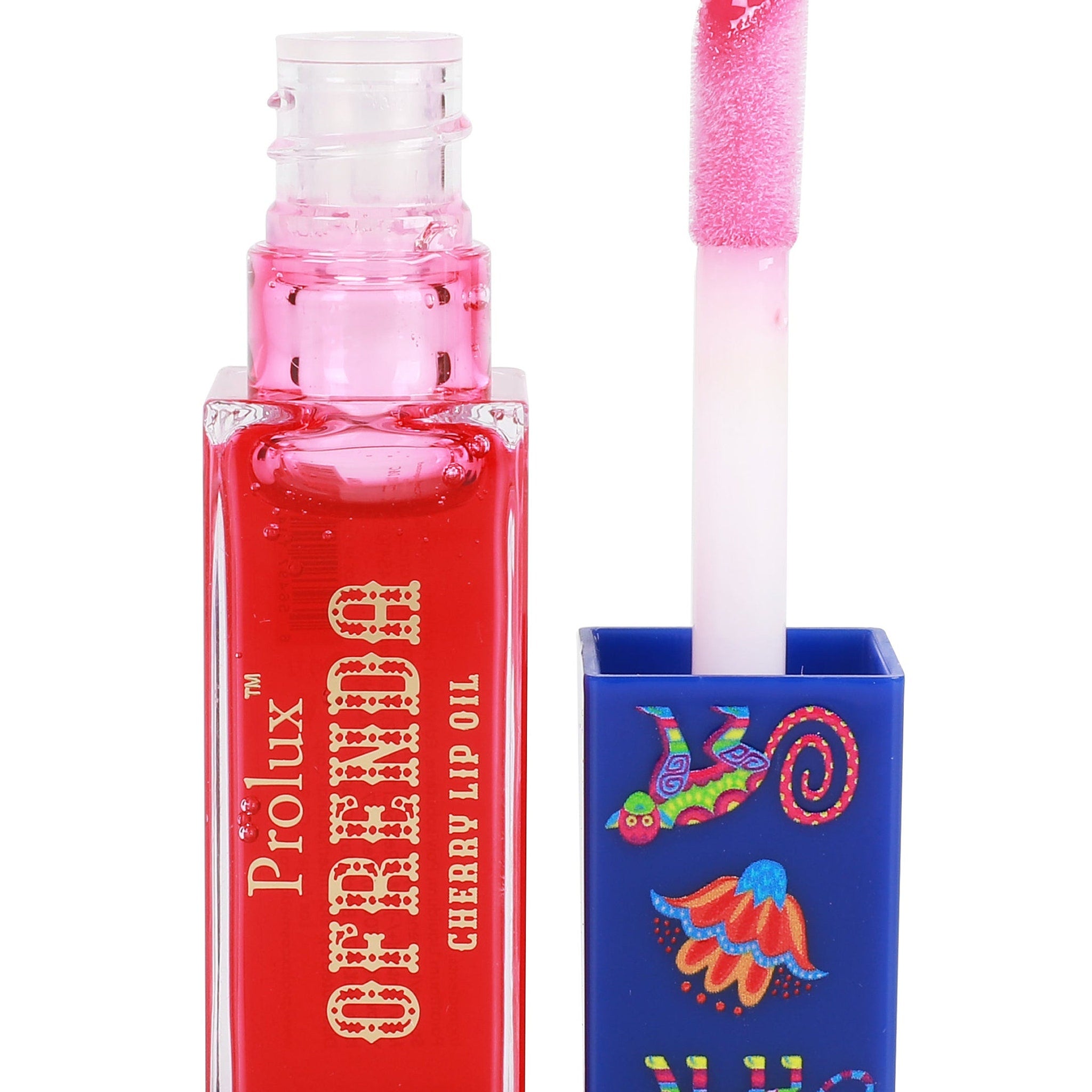 Lip oil bottle, red liquid, pink applicator, blue decorated lid, Prolux brand name visible