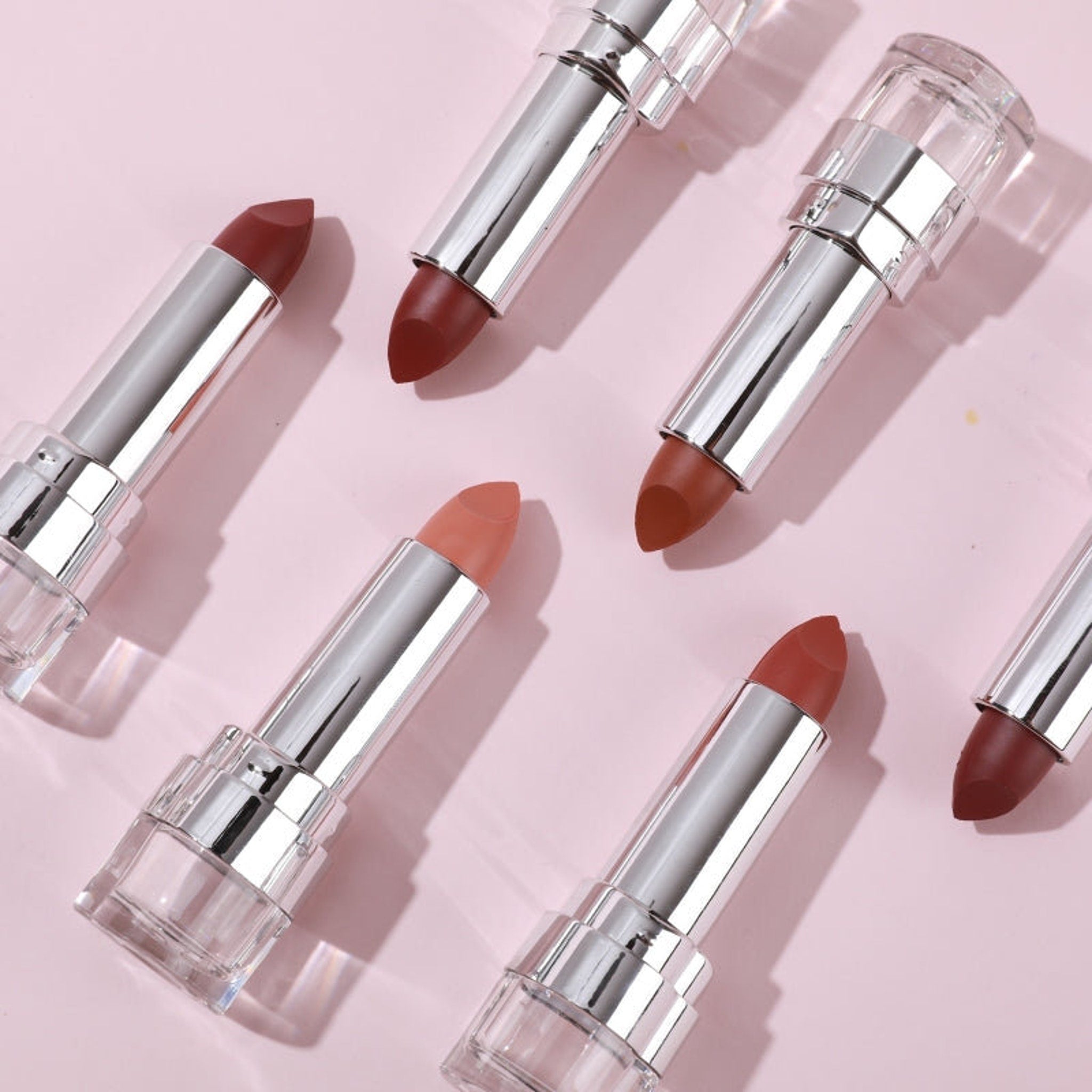 PXLOOK Pout About Lipstick in sleek black tube with gold accents, showcasing bullet shape and satin finish