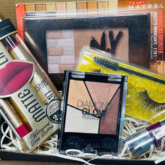 Side view of surprise beauty box showcasing assorted shimmering eye shadow pans in vibrant hues