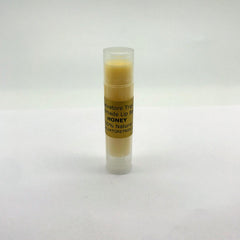 Lip balm tube with clear cap, yellow balm, and Salvatore Tripi label