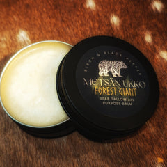 Balm jar with black lid, light yellow balm, and brand label on a brown fur background