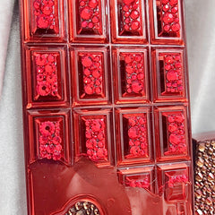 Side view of Chocolate Bar Eyeshadow Palette showing blinged glam shades in rectangular pans with gold trim