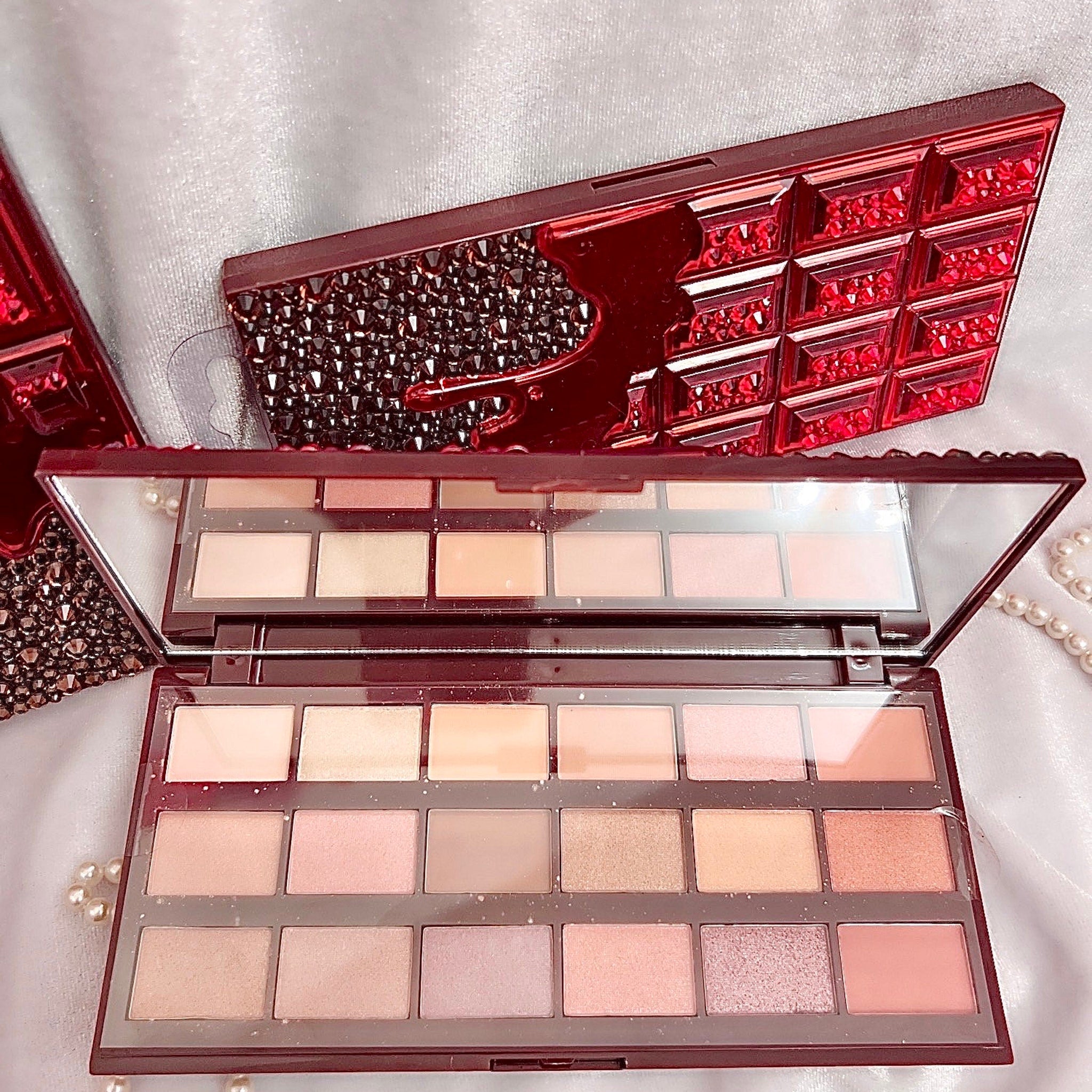 Chocolate Bar Eyeshadow Palette open with shimmering bronze and gold shades arranged in rectangular pans