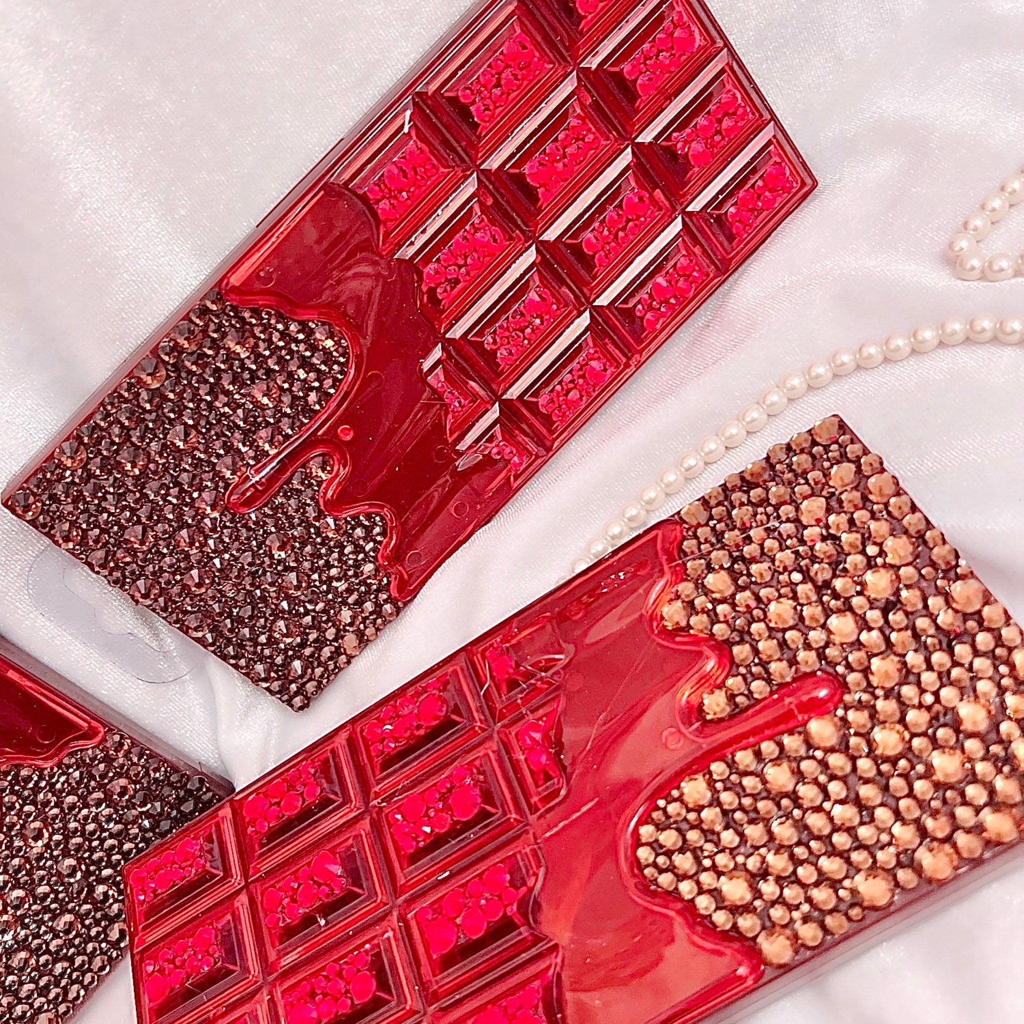 Close-up of shimmering bronze and gold eye shadow pans in chocolate bar palette with sparkling glitter particles