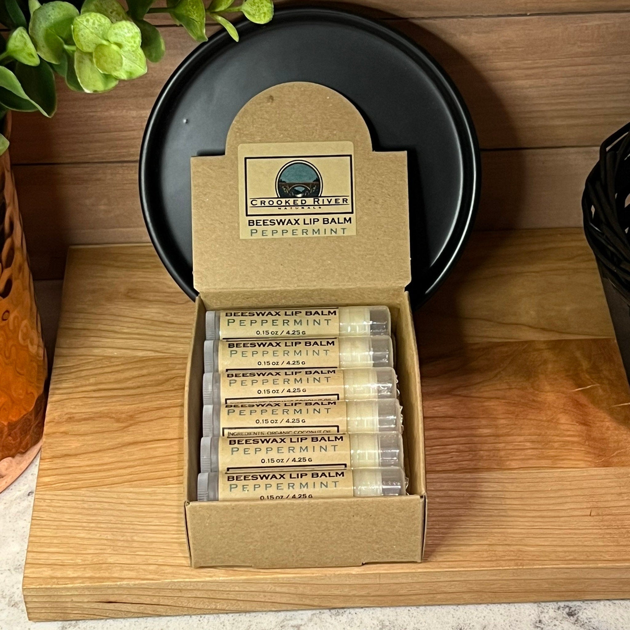 Beeswax lip balm tubes in a cardboard box, clear tubes with white labels, Crooked River brand