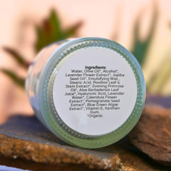 Ingredients label on a glass bottle, white text, green rim, and brown surface
