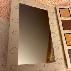 Close-up of Winnie the Pooh eyeshadow palette showing honeycomb design with warm gold and brown matte shades