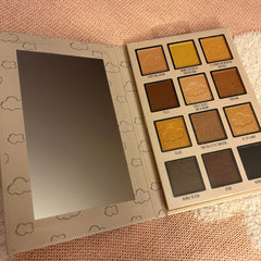 Side view of Winnie the Pooh eyeshadow palette showing honeycomb design with warm brown and gold shades