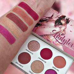 Eye shadow palette with pink, mauve, and glitter swatches, Ladylove brand makeup colors shown