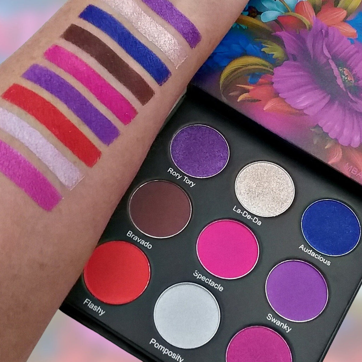 Flamboyant Eyeshadow Palette with 12 vibrant matte and shimmer shades in a sleek black compact