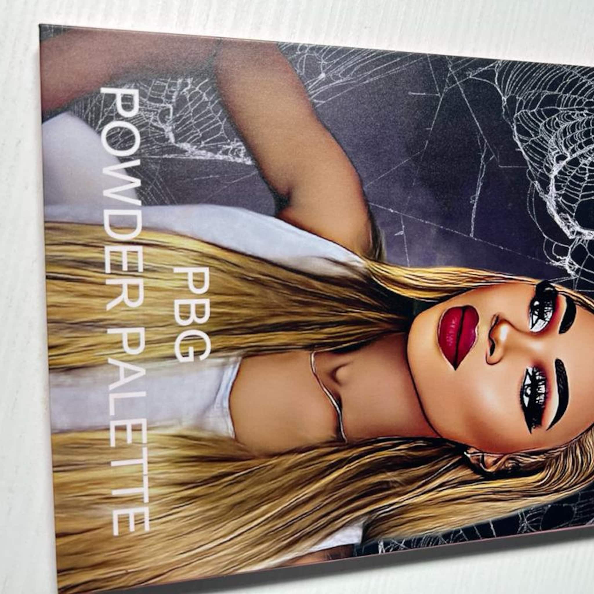 Powder palette with blonde hair, red lips, and white text on dark background