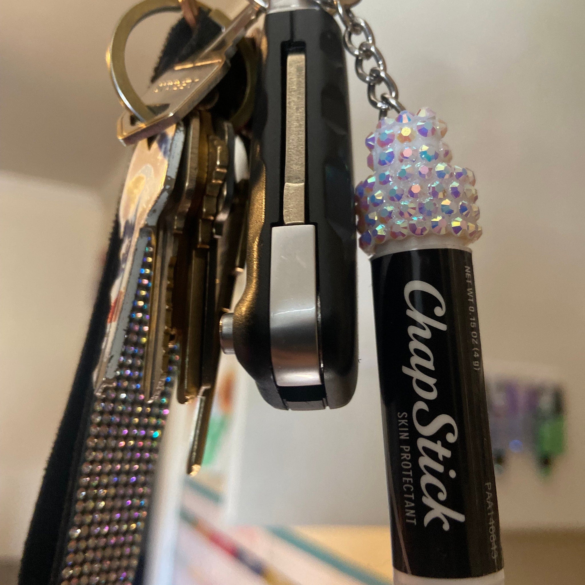 ChapStick skin protectant lip balm in black and white with rhinestones on a keychain