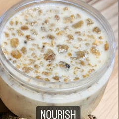 Creamy white and brown food in a clear jar, with "NOURISH" text at the bottom.