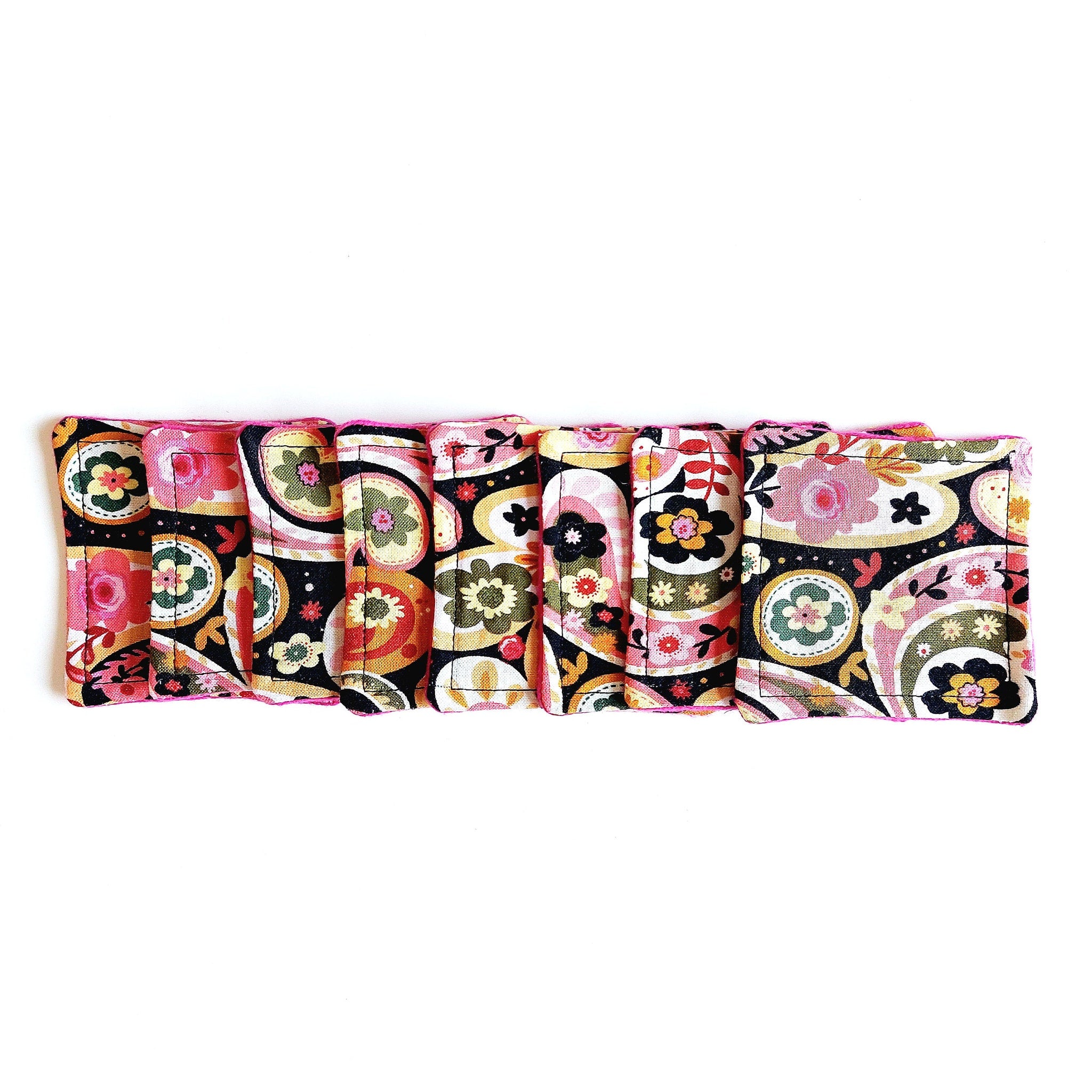 Coasters with floral pattern, pink trim, and fabric material