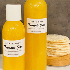 Close-up of golden turmeric liquid soap in clear bottle with loofah, showcasing natural vegan formula and rich texture